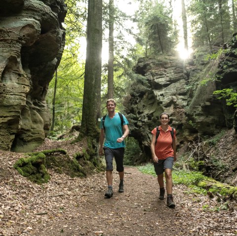 Wanderer in der &quot;Schweineställe&quot; genannten Schlucht im Felsenland Südeifel, © Eifel Tourismus GmbH / Dominik Ketz